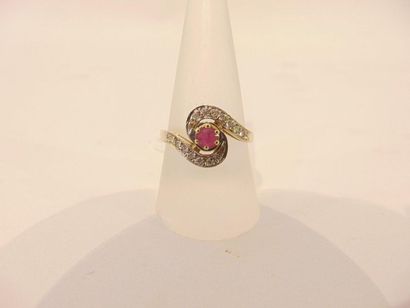 null Ring in 18 karat yellow gold set in a swirl with a ruby and brilliants, punched,...