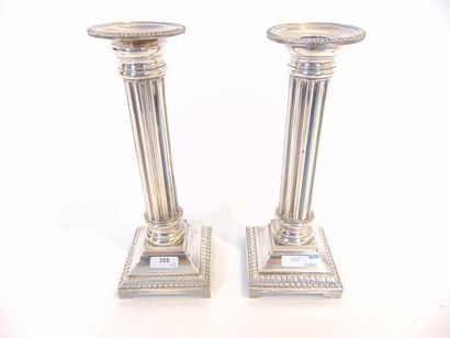 null Pair of torches in column, 20th century, silver plated metal, h. 23 cm; a snuff...