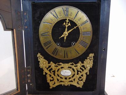 null A late 19th century blackened wood clock with brass rods and bronze ornaments,...