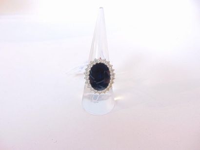 null Oval ring in 18 karat white gold set with a black sapphire in a diamond setting,...
