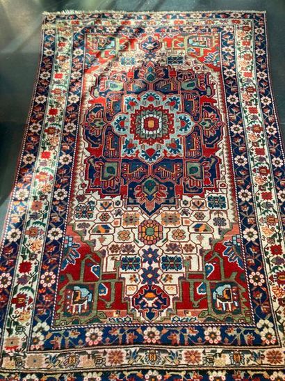 null Nahavand style Persian carpet with central medallion and polychrome stylized...
