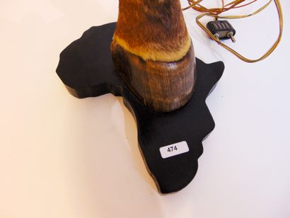 null Paw mounted as a lamp on a blackened wooden base (contours of Africa), h. 40...