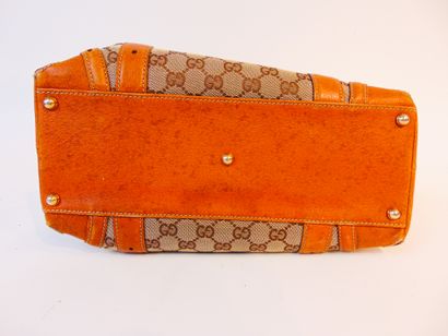 GUCCI Monogrammed canvas and leather handbag, l. 31 cm [slight alterations].