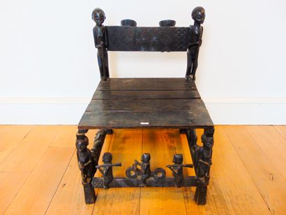 ART TRIBAL A seat with a rich historiated decoration of figures in the round, 20th...