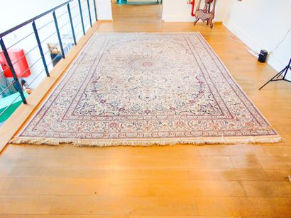 null A large Persian Nain carpet with medallion and floral arabesques on an ivory...