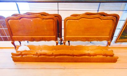 null A pair of Louis XV style beds, 20th century, moulded oak with light patina,...