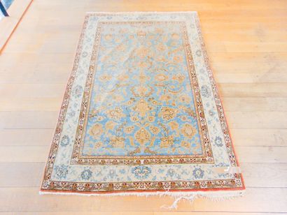 null A Tabriz-style Persian carpet with floral scrolls on an azure field, 222x139...