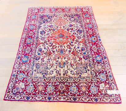 null A Keshan-style Persian prayer rug with floral scrolls on an ivory field, 213x146...