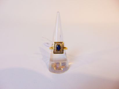 null Yellow gold ring (18 carats) set with an oval sapphire in a rectangular diamond...