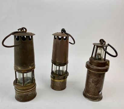 L'UNIVERS DE LA MINE Set of three miner's lamps, a patinated bronze subject and a...
