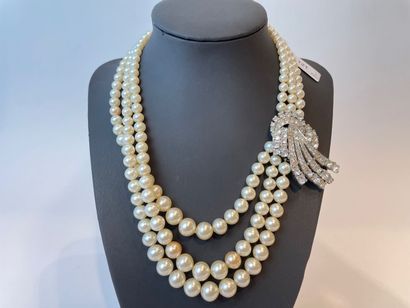 null Necklace with triple strand of pearls and rhinestone ornaments; a small fancy...