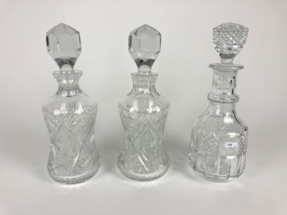 null Three decanters, one pair, XXth, cut crystal, one with label, h. 33 cm appr...