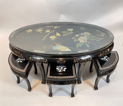 null Chinese oval coffee table and six nesting stools in a row, 20th century, black...