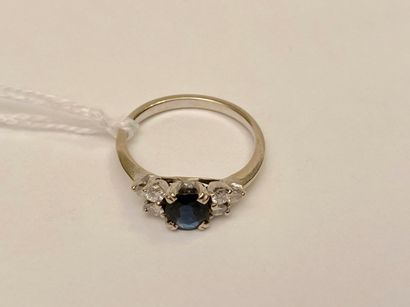null Ring in white gold (750 thousandths) set with an oval sapphire with six diamonds,...