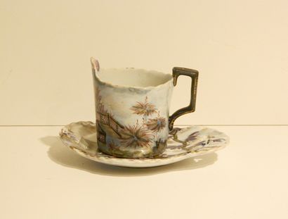 SAINT-CLÉMENT Tasse et sa soucoupe contournée à décor extrême-oriental en bleu sous...