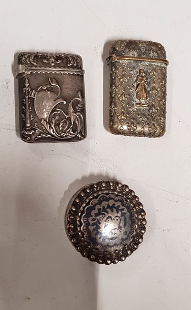 null 2 silver match cases, one decorated with a dragon and the other with fleurs-de-lis....