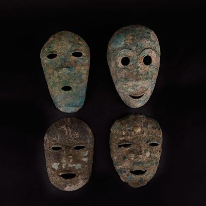 null Set of four bronze funerary masks.
China, Liao style
H. 20 to 23 cm