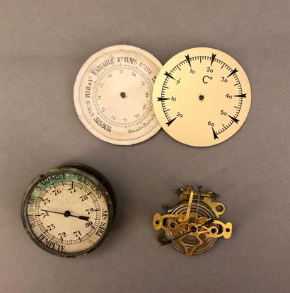 null Two aneroid barometer movements.