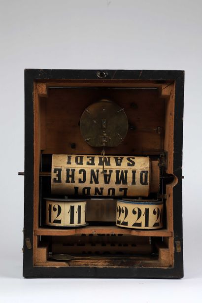 null Ebonized wood 'Redier' system clock with roller calendar (back door replaced)....