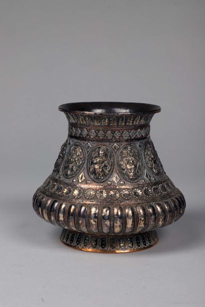 null Floriform pot in silver plated copper, with decoration in repoussé of divinities...