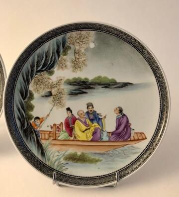 null Pair of porcelain and enamel plates decorated with four characters in a boat,...