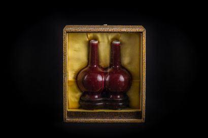 Two small bottle vases with long necks, joined...
