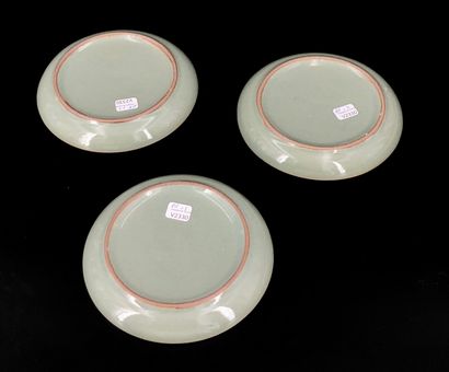 null Three celadon glazed stoneware mukozuke plates, decorated with a crane inlaid...