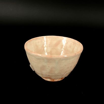 null A chawan tea bowl with a flared wall on a small notched heel, made of red stoneware...