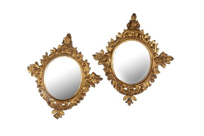  A pair of giltwood oval mirrors decorated with staples and foliage. 18th century...