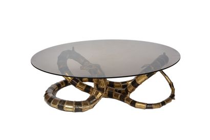  HENRI FERNANDEZ. Coffee table, metal base in the shape of a snake, round glass top....