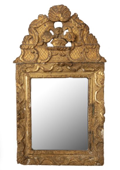 A small molded and gilded wood mirror with...