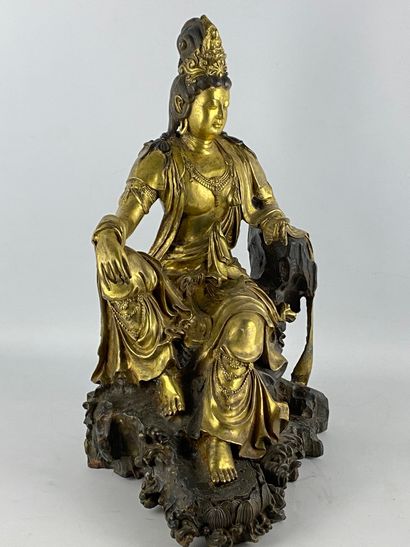  Guanyin in gilt bronze China Depicted seated...