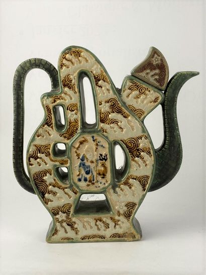 A stoneware polychrome enamelled character-shaped...
