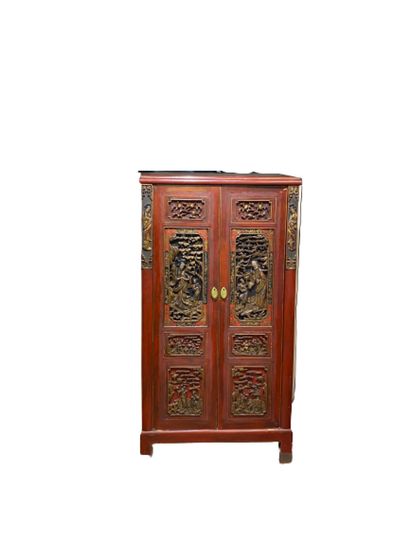 A red lacquered and gilded carved wood cabinet...