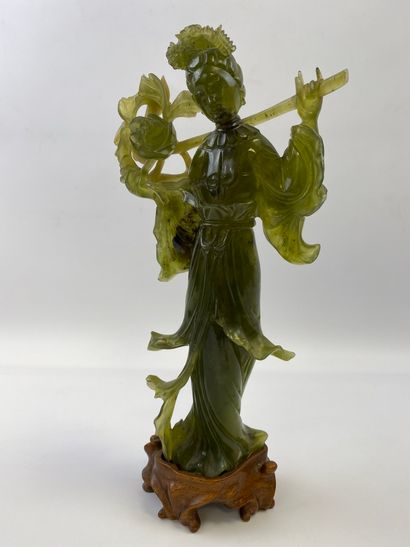  GUANYIN IN SERPENTINE China She is represented standing on a wooden base. (chips)...