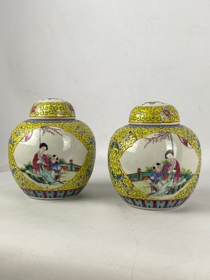  Pair of small porcelain and enamel ginger pots in the famille rose style on a yellow...