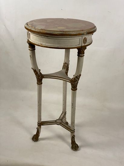 Circular pedestal table in painted and gilded...