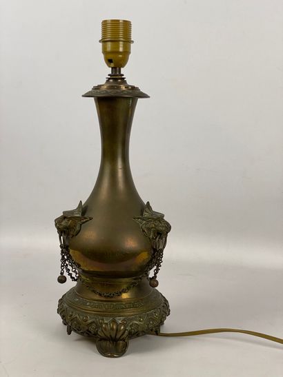 Brass tripod lamp decorated with three lion...