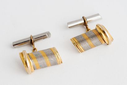  CARTIER 
Pair of yellow gold (750) and steel cufflinks with grooved decoration 
Signed...