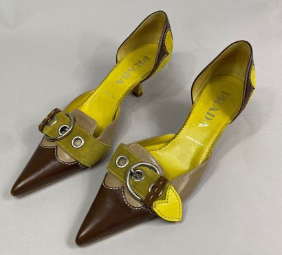  PRADA 
Pair of yellow, beige and brown leather pumps with pointed toe and buckle...