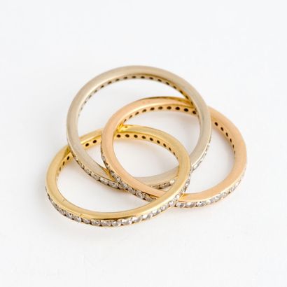  American wedding band in two-tone gold (750), consisting of three interlaced rings...