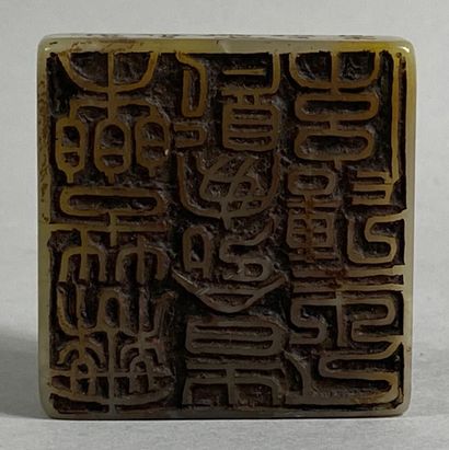  CHINA, 20th century 
Carved hard stone seal, square section, with the effigy of...