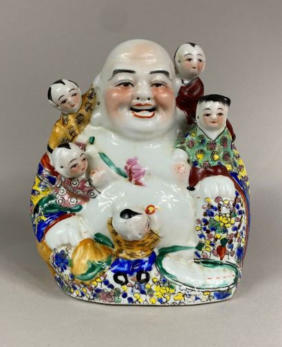  CHINA, 20th century 
Laughing Buddha in polychrome enameled porcelain surrounded...
