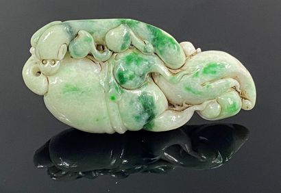  CHINA, 20th century 
Roller weight in jade carved in a white stone with scattered...