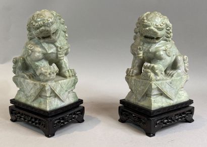  CHINA, 20th century 
Pair of green hard stone Dogs on their wooden bases