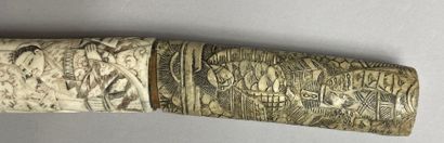  JAPAN - 20th century 
Wakizashi type sword. Bone frame carved with wise men, children,...