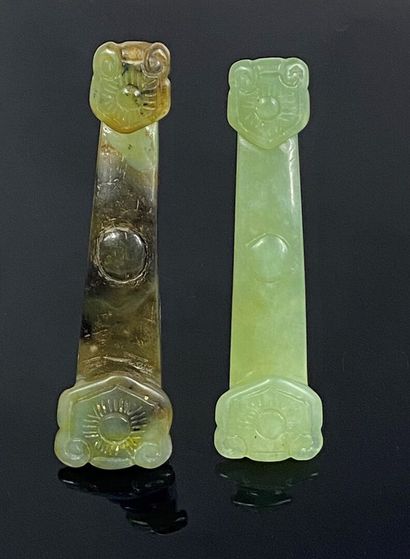 CHINA, 20th century 
Set of two bowenite and green hardstone ruyi scepters. The...