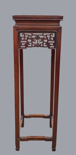 CHINA, 
Square shaped high pedestal made of carved and openworked wood. The belt...