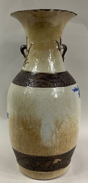  CHINA, NANKIN 
Blue enamelled stoneware baluster vase on a cream background decorated...