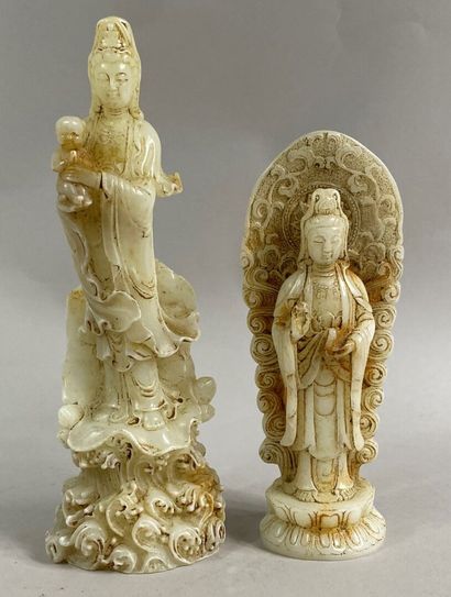  CHINA, 20th century 
Set of two white jade subjects representing a deity. One holding...